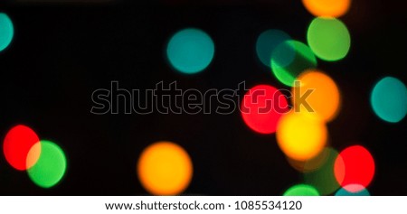 colorful round spots of light on a dark background
