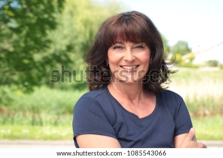 Beautiful happy woman outside Royalty-Free Stock Photo #1085543066