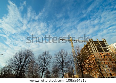construction site with crane blue sky with white clouds on background