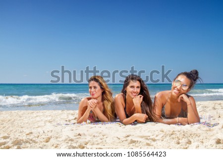 Beautiful girls laying and smiling on the beach