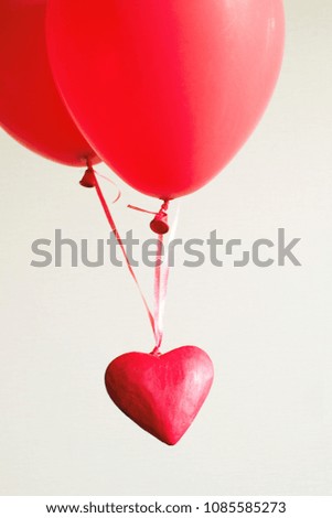 Red decorative heart in red balloons on a light background. Romantic image