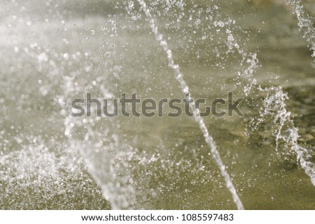 Flow of water fountain. Water splash in a fountain, abstract image.