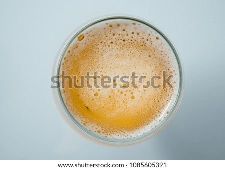 A glass with fresh beer and foam