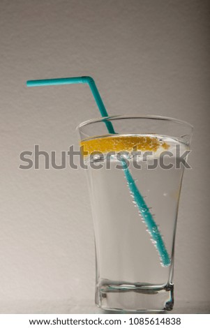 A glass of fresh drinking water and a lime. mineral water . Gray background Mineral water