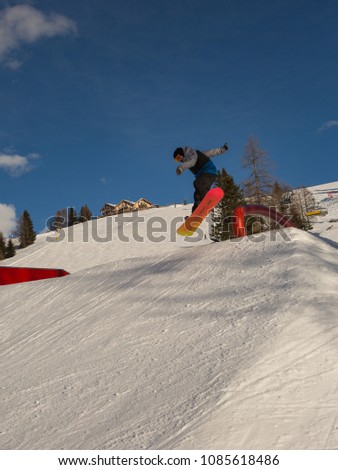 Snowboarder in Action: Jumping in the Mountain Snowpark.