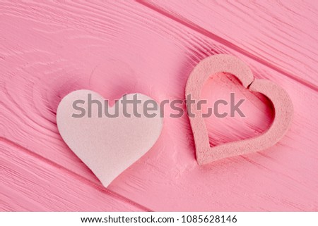 Two heart shapes on pink wood. Heart pumice stones on colorful wooden background. Valentines holiday design.