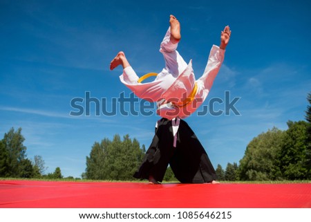  Two karate men fighting in a outdoor 