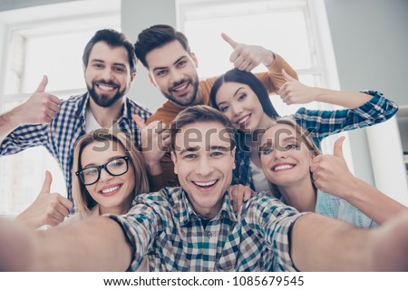 Self portrait of economists, students, financiers, lawyers in casual outfit showing thumb up with fingers shooting selfie on front camera with joyful cheerful expression having leisure, timeout