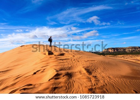 A Man taking picture in the desert, Coral Pink Sand Dunes State Park, Utah