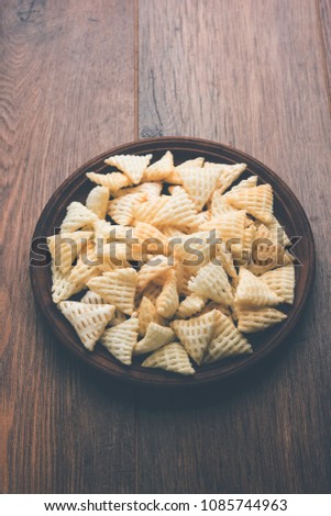 Triangle shape Fryums Papad is a crunchy Snack Pellets served in a bowl