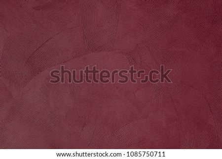 Focus on a burgundy colored wall with wave shapes Royalty-Free Stock Photo #1085750711