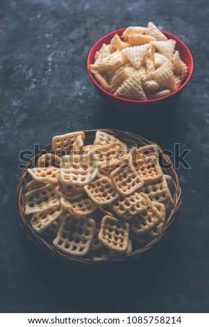 Triangle and Square Fryums Papad is a crunchy Snack Pellets served in a bowl
