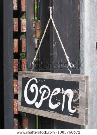 Message Open. Wooden board sign in font gate entrance cafe garden outdoor