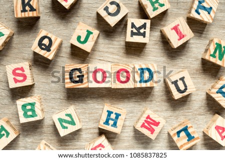 Letter block in word good with another on wood background