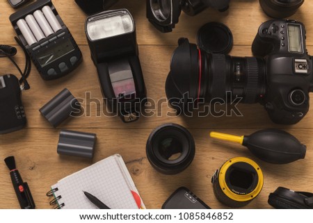 Photo equipment. Top view of diverse personal equipment for photographer or creative designer on wooden table, copy space