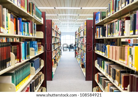 library setting with books and reading material (Please note that many books with legible titles are filler titles that only state the 'type' of materials contained within and date)