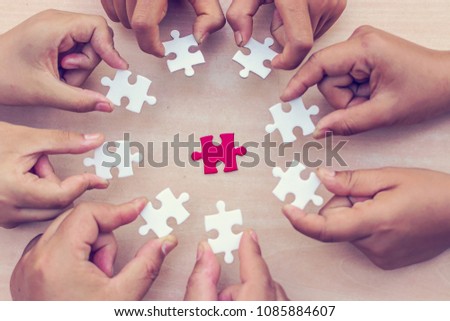 A pieces of jigsaw puzzle will be matching. Business concept. Red and white puzzles. Royalty-Free Stock Photo #1085884607