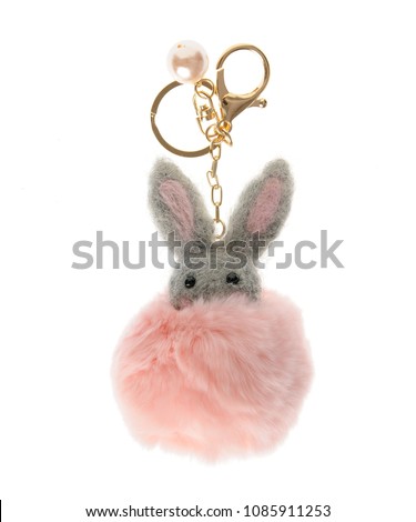 beautiful key chain luxurious fur ball-pink-colored animal isolated on white background Royalty-Free Stock Photo #1085911253
