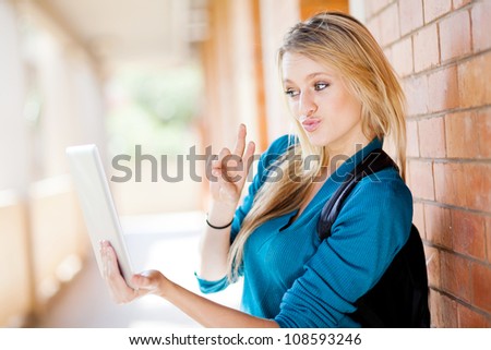 cute female college student using tablet computer communicate with friends
