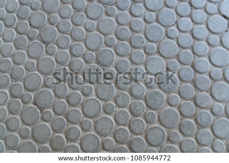 round large gray stone plates laid on the floor - macro
