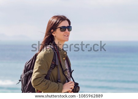 A girl tourist walking by the coast