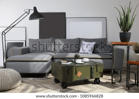Loft interior with sofa, coffee table, indoor flowers and floor lamp
