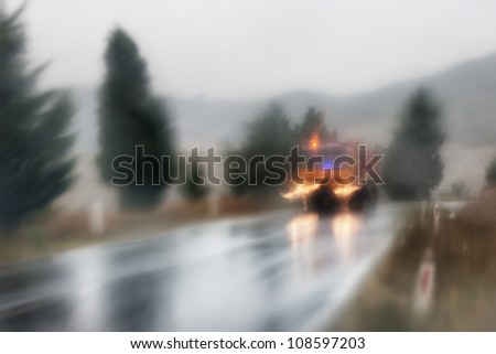 Tow truck on the road in the rain in Tuscany