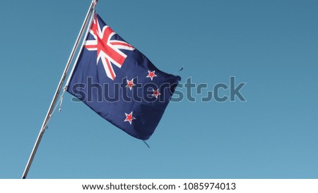 New Zealand Flag on Clear Blue Sky Background
