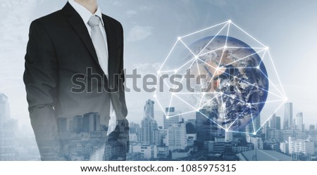 Global network and international global business. Double exposure businessman and city background with global network connection hologram technology. Element of this image are furnished by NASA