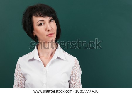 woman posing and expressing various emotions on school Board background, learning concept, Studio shot