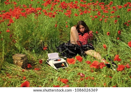 Employee working outside in poppy flower field