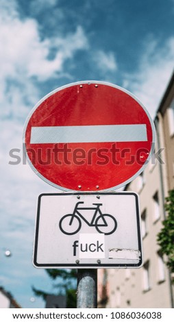 Interesting road sign. Street sign directing traffic along a one way street, with the exception of cyclists.