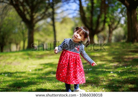 baby girl play at spring forest garden