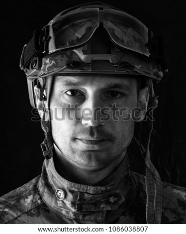 close up portrait of handsome military man. Macro shot on black background looking at camera