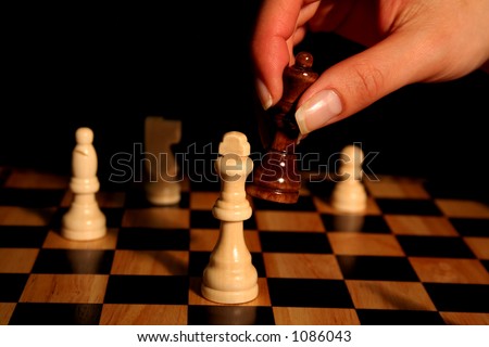 A photo of a woman winning at chess