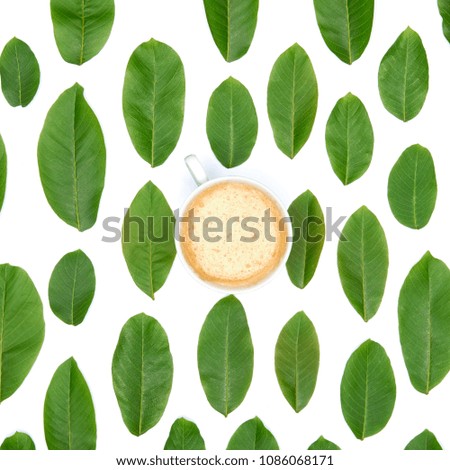 Coffee cup on green leaves background. Good morning coffee flat lay.