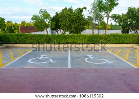 Wheelchair sign at car park reserved for people living with disabilities person.