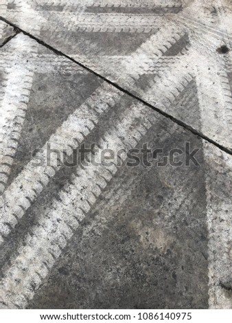 Abstract background tire tracks on cement floor, Tire trace on the ground, tire marks on cement floor.