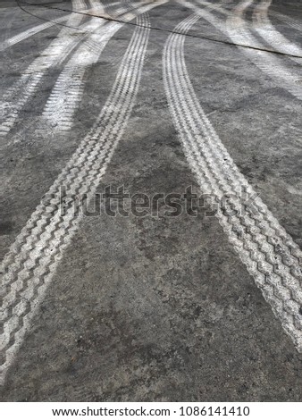 Abstract background tire tracks on cement floor, Tire trace on the ground, tire marks on cement floor.