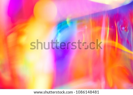 Abstract holographic festive psychedelic pop background of fluid lines and swirls in vibrant neon rainbow colors and glowing light
