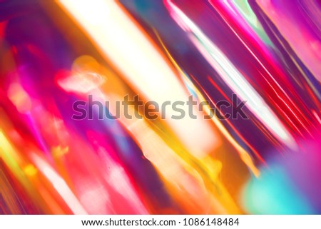 Abstract intense electronic club background of shiny glowing diagonal lens blur light streaks in vibrant saturated spectrum colors Royalty-Free Stock Photo #1086148484