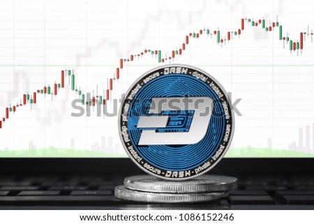 DASH (DigitalCash) cryptocurrency; physical concept dash coin on the background of the chart