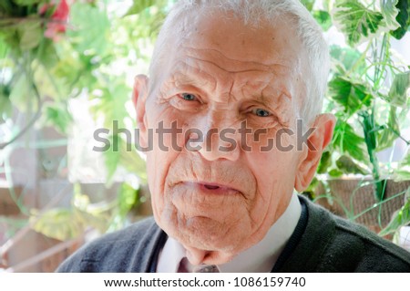 Portrait of Grandfather. Elderly man smiling and looking at camera