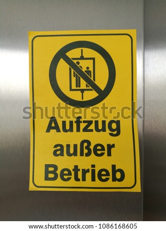 Yellow sign with the note Elevator Out of service Detail with German Word Aufzug au er Betrieb