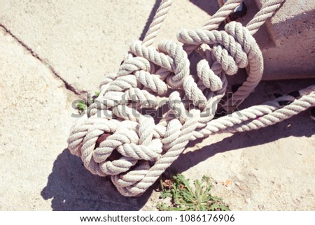 Sea knot in port. Marine equipment background. Navy rope. Summer sail.
