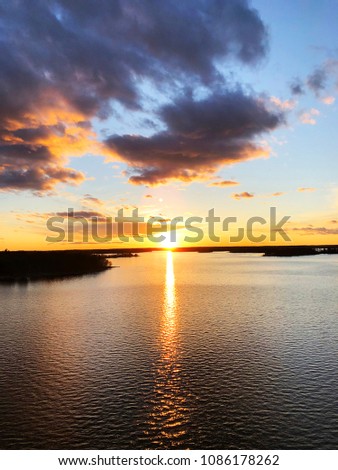 Aerial view of a Sunset sky background. Aerial Dramatic gold sunset sky with evening clouds over the sea. Stunning sky clouds in the sunset. Sky landscape. Aerial photography.