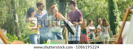Group of friends having a barbeque in a park
