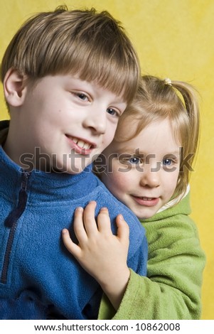 Portrait of happy children on a yellow background