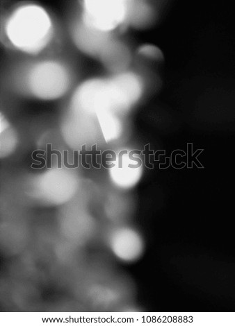 Abstract out of focus lights coming from the mother nature with abstract background of Black color. Abstract background of Black and White color. Image is good to use as an Light Overlay. 