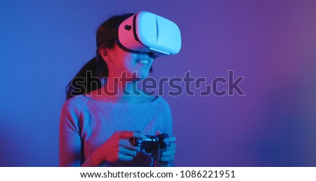 Woman play game with VR at night 